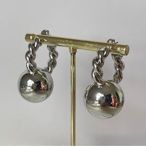 New rhodium plated twisted, round bead hoop earrings, silver color.